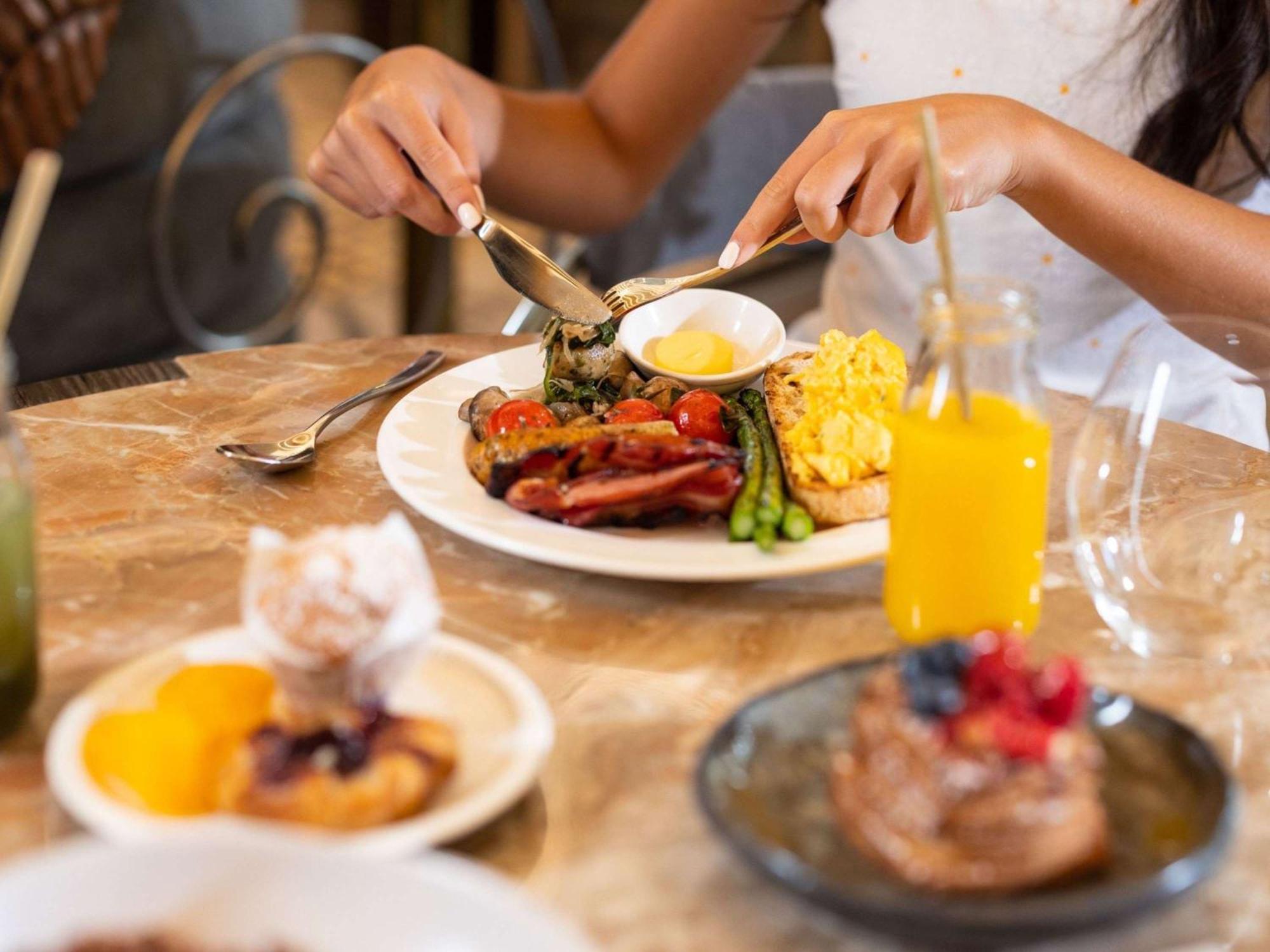 The Playford Adelaide - Mgallery Exteriér fotografie A woman eating breakfast